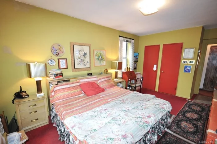 Large corner bedroom has two closets and covered hardwood floors.