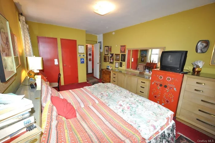 Large corner bedroom has two closets and covered hardwood floors.