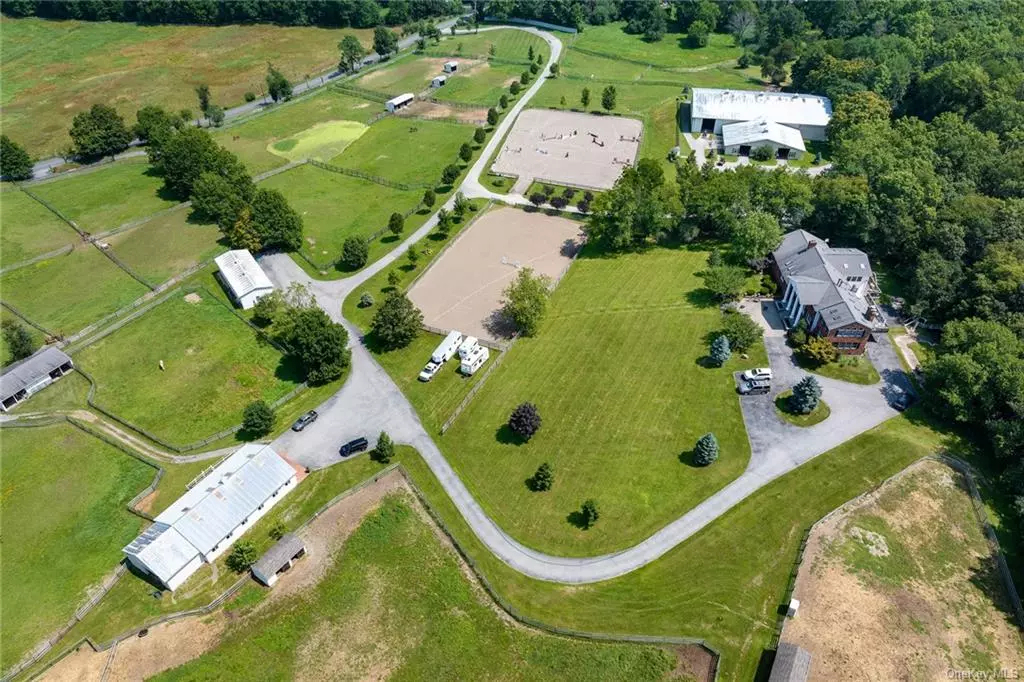 Embrace an equestrian lifestyle with this exceptional horse property. Picture a world where rolling pastures, lush meadows and pristine riding arenas become your daily backdrop. As you pass through the gated entrance, a world of equestrian wonder unfolds before your eyes. Main barn boasts 13 stalls and an attached 75&rsquo;x133&rsquo; indoor arena with sprinkler system complemented with footings from Footing Solutions/Geotez, 2 large outdoor wash stalls thoughtfully designed with attached paddock along with 3 outside stalls with one indoor wash stall both equipped with convenient hot and cold water access. The lower barn further enhances the facilities with 15 stalls and an outdoor wash stall. As you explore the property you will find 5 outdoor stalls thoughtfully paired with attached paddocks and an additional 5 outdoor stalls with water access. The presence of 3 run-in sheds and 21 paddocks ensures that your horses have plenty of space to roam and relax. Whether it&rsquo;s dressage or jumping the two outdoor riding arenas both with sprinkler systems and footings by Footing Solutions are perfect for refining your equestrian skills. Main house has 5 bedrooms and 4.1 baths. Although this home requires improvements, this is your invitation to combine your passion for horses with your renovation dreams, resulting in a place where memories are made and equestrian aspirations come true. Great potential for a new owner to take over an income producing equestrian estate.