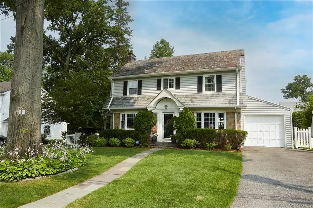 Charming and sunny Dutch Colonial home located in the north end of New Rochelle On Rose Hill Ave. Main level has entry foyer, updated open kitchen with custom Kraft maid cherry cabinets, stainless steel appliances, granite countertops, radiant floor heating, dining area/ family room, formal living room/Fireplace/ original built-in shelving, powder room, sliding barn door to 3 season porch and beautiful crown moldings throughout. Second floor has large master bedroom with 2 walk-in closets and full master bath, 2 additional bedrooms each with large cedar closets, and updated hall bath .Level backyard with swing set/ sand box and trex deck. Playroom and storage room in the basement, updated laundry room with new high end washer/dryer/ door to back yard. Additional updates include , windows, furnace, hot water heater,  dehumidifier system , ductless AC in all rooms. Close to schools, shops, transportation and houses of worship. Taxes do not reflect star savings of $1, 551.00