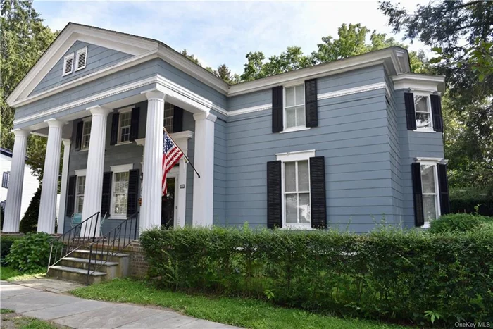 This prominent Greek Revival residence stands in testament to fine 19th century architecture. First built c. 1830 with addition in 1850, the majestic temple front greets and graces an expansive portico. The front sidewalk lures from the heart of the charming and bustling Village of Rhinebeck. Detached and generous two car garage includes an upper level for storage and/or potential studio or workshop. Two additional sheds and carport. The landscaped property includes a secret garden and space for simple enjoyment. Solid construction with meticulously placed fieldstone foundation. Cement floor basement with log posts accessible from interior and Bilco doors. Period craftsmanship and architectural detail throughout. If your preference is historic charm updated to your own tastes and needs, this 19th century diamond awaits! 2.5 miles to Rhinecliff train with Amtrak to Penn. 90 miles to NYC. More pics to come!