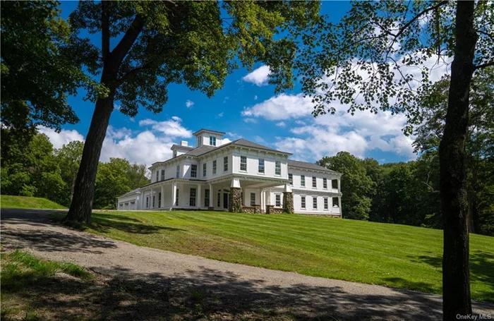 A classic Hudson Valley 1830s house gets a modern makeover. This definitive 1930s colonial was completely transformed into a modern mansion in 2022. Innovative and luxurious, the five-bedroom, 7.5-bathroom home rests on 12.28 acres and features 6, 800 square feet of living space. Center-hall colonial style, including herringbone hardwood floors, traditional windows, and pristine white walls, combines with modern design. The living room features a soaring fireplace wrapped in marble, while the chef&rsquo;s kitchen boasts a walk-in refrigerator, heated floors, multiple oversized stainless-steel appliances, and a duo of waterfall marble islands. An enormous light-filled dining room, media room, and a resort-like pool area make this home ideal for entertaining and relaxing. The primary suite includes laundry, a gym area, and a spacious bath, and four additional bedrooms are equipped with ensuite baths. A Lutron HomeWorks system, a nine-zone Sonos system, efficient heating and cooling systems, and an alarm system with 17 security cameras are also included.  Outside, the home includes a raised bed garden, a private pond, a three-car garage with an EV charging station, and various accessory outbuildings for work or hobbies. Set on the eastern side of the Hudson River, Garrison is just one hour from NYC.