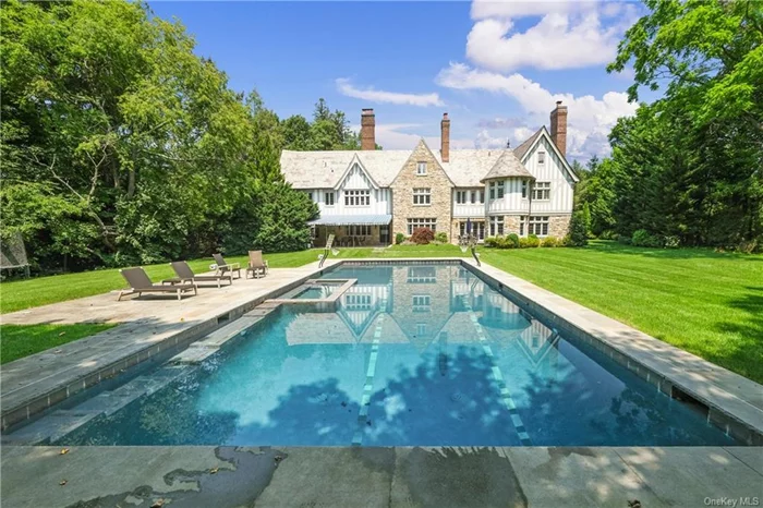 Exceptionally private Manor home with an inviting circular courtyard, oversized inground heated pool and landscaped grounds splays prominently on beautiful parklike 1.49 acres. Nested discreetly in Murray Hill, a brilliant addition (2015) exquisitely captures the intimate luxury of this home with a true gourmet kitchen, anchored by an oversized marble clad island (seats 5), custom designed cabinets, leathered granite countertops, multiple sinks with disposals, Viking French cooktop with two full size convection ovens, three dishwashers, separate full refrigerator and freezer, and a walk-in pantry all overlooking the sun-drenched breakfast area with French doors to the expansive yard and pool, adjoining the family room with turret shaped computer area all resplendent with oak built-ins - everything you ever wanted and more: glass enclosed Loggia complete with radiant heated stone flooring, mudroom with built-in lockers and cubbies, full bath, changing room and laundry (#1) leads to a 3+ car garage with an upstairs sanctuary/personal passion space (home office/yoga or art studio/guest suite) with full renovated bath. Complimentary to the traditional spirit and quality of this Manor home, the addition and updates seamlessly integrate with the grandeur of a traditional dining room, living room and sizeable sun room with radiant heated floors and offering access to the stone patio and yard. Escape upstairs to the primary bedroom sanctuary, with entrance vestibule, vaulted beamed ceiling, two bespoke walk-in closets, a roomy LUX bath with honed limestone floor, double vanities with shell leaf limestone sinks, self drying Jacuzzi tub for two, shower stall, water closet and a separate turret designed study (meditation room) wrapped in windows. There is an en-suite bedroom, two additional bedrooms sharing a renovated bath and laundry (#2) on this floor. Fabulous finished upper level offers a playful recreation space with built-in trundle beds, separate guest room (or office) and full bath. The lower level is just as fabulous, with a second recreational space and lounge plus additional separate room for a future media room. A supremely private Shangra-La, magnificent for entertaining large gatherings, private soirees or intimate evenings. A pleasure to visit - an honor to own!