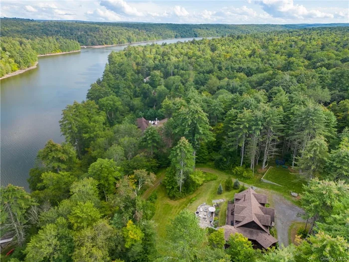 This custom Adirondack Lake Home is loftily placed on a majestic 5.38 acres with 393 feet of prime lake frontage on the Swinging Bridge Reservoir. The Lumberland phase of this community is known to have forever wild views as the restrictions on the opposite shoreline prohibit residents from building within 300&rsquo; of the reservoir. Construction on this lake side beauty was completed by the premier builder within The Chapin Estate. 3, 162 square feet of luxury rustic style living with full deck with covered area overlooking water. Creative outdoor living and play areas were thoughtfully designed that significantly increase the use of the natural outdoors. The home has 4 bedrooms, 4.5 baths, gourmet kitchen, a fireplace, 2 firepits, large sideyard/play area and gravel road leading down to the dock, shed and meticulously manicured lake frontage. All within a gated preserve featuring a member&rsquo;s only Lake Club. Located at the Chapin Estate, a 4-season gated residential preserve tucked discretely amidst 2500+/- acres of pristine forest lands and bordering 14, 000 acres of protected conservation lands. Unique attributes include: 2000 acres of fresh water reservoirs and trout streams; 9+ miles of hiking, biking and riding trails. Minutes from Bethel Woods Performing Arts Center. 2 hours from NYC, even less from North Jersey. Minutes from Bethel Woods Performing Arts Center. 2 hours from NYC and even less from North Jersey. 15 minutes from Monticello Motor Club, Resorts World Catskills, Kartrite Water Park and Yo1 Wellness Center. Boutique Hotel with restaurant, bar and spa to be available to residents. (*Short term rentals are not permitted. Rental minimum of 3 months no more than twice per year.)
