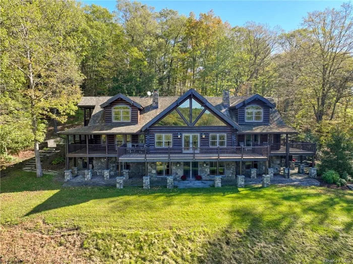 This Breathtaking Custom Log Estate was commissioned by the current owners in 2003, and the Custom Stone and Cedar Guest Home built in 2006 is simply indescribable. Massive Logs from a Mill in Tennessee form the basis of this home. Extensive Stone Masonry on both homes and throughout the landscaping creates an age-old aesthetic of timelessness. Nestled on over 40 acres (ADDITIONAL LAND AVAILABLE TO PURCHASE) with a large pond and stream running through the property, this home is the pinnacle of privacy, nature, and relaxation. The Log Estate comprises over 7000sf of luxury living, four bedrooms, and 4 Full and 1 Half baths; this includes a main level and upper-level primary suite with walk-in closets and fully renovated private en suite bathrooms. Two Stone fireplaces in the dining room and great room provide warmth and ambiance in the colder months, and the full wet bar is perfect for entertaining. Custom Wood kitchen cabinetry with Subzero fridge and Wolf stove leads out to a wrap-around porch and brand new Hot Tub along with a large bluestone patio surrounded by towering stone walls with custom grill built right in, extending endless comfort and luxury to the outdoor living space. The lower level offers an oversized mudroom, spacious walkout entertainment room, pool table leading to a custom movie theater media room, and full bath. The exquisite guest home includes over 1400sf of living space. It is privately situated in its oasis away from the leading estate, featuring stone and cedar siding, copper gutters, a cedar roof, an additional custom stone masonry fireplace, and two bedrooms and two full baths. Pictures simply can not do this listing justice. Efficient radiant-zoned heating, a backup generator, and a detached, two-level timber frame garage are just a few more examples of how no expense was spared on this unique property. This home was designed and meticulously built using only the best materials and lovingly maintained in the same manner.