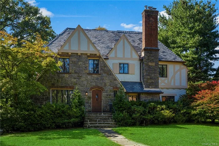 High-end rental in Larchmont Woods, walking distance to Larchmont village and train station, on a beautiful tree-lined street. This stunning Tudor home showcases original architectural details with modern amenities. Among its many features are: a sunlit gourmet dine-in kitchen with quartzite countertops and stainless steel appliances, updated bathrooms, generously-sized rooms and hardwood floors throughout the house. A magnificent sunken living room with a unique fireplace, an elegant formal dining room, an inviting playroom/family room on the lower level, and a huge primary bedroom are additional highlights. The 5 spacious bedrooms offer the possibility of working from home in a very quiet setting. The fenced backyard provides privacy and has a stone patio overlooking the exquisite terraced garden. The Leatherstocking Trail is one street away. Feel on vacation all year round with the proximity of the Long Island Sound and an enviable 35 minute commute to NYC!