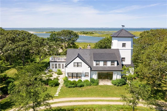 One half of private, Ram Island, offers a complete, self contained luxury resort experience. Stylishly restored on 15 acres, the main house centers around an antique windmill-- now an elevated office--overlooks Sebonac Creek, the blue waters of Peconic Bay and the green hills of historic National Golf Links. The main house has lavish living areas coupled with soft finishes and fixtures. Featuring a glass dining room, 4 luxurious bedrooms and baths and a primary suite with roof deck with soaking tub. Across the path, a wellness building houses a yoga/exercise room, sauna and shower section, massage room, meditation roost, plus a kitchen, bedroom and bath. Perfect for entertaining with a full sized separate guest house. A boat house opens to the deep water dock with room for large vessels. A beautiful in-ground gunite pool, hot tub, fire pit overlooking the inlet and bay compliment the grounds with arbors, gardens, walking paths, and wide lawns. The ultimate vacation experience.