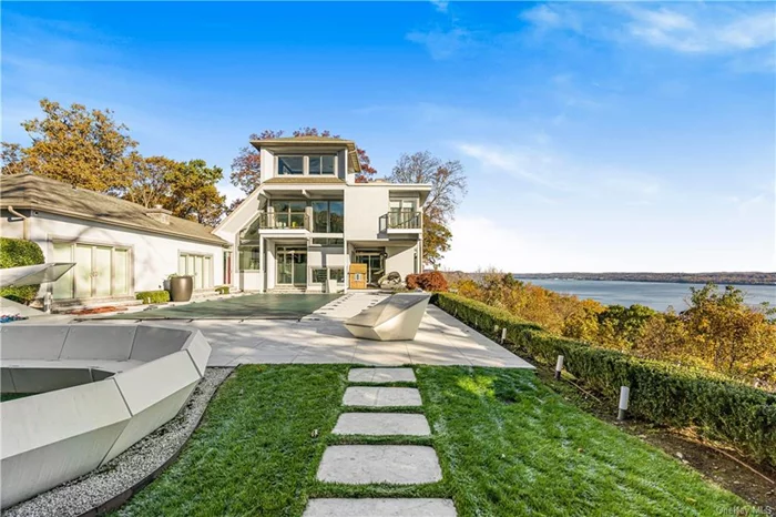 Experience the epitome of modern luxury living at this stunning home on Tweed Blvd in Nyack, NY with breathtaking Hudson River views. Step inside to discover a renovated home, where every detail exudes sophistication. The main level features a glamorous sitting room with a dining room and fireplace, all sharing the magnificent river views. The Snaidero Kitchen is a chef&rsquo;s dream, equipped with Sub Zero & Wolf appliances, Concetto Countertops, and a breakfast room with a waterfall bar and Lutron lit counters. The primary suite features a fireplace, Venetian plaster, double sliding doors to the limestone terrace and pool, Lutron shades, dual walk-in closets, and a lavish bath with a center rainfall shower, Toto lavatory, dual sinks, and a hand-carved marble tub. The second floor offers a lounge and bedrooms with Mirrored TV&rsquo;s, while the third floor features an office with 180-degree Hudson views. Entertain in style with a magnificent pool, terrace, summer kitchen, and a billiard room.