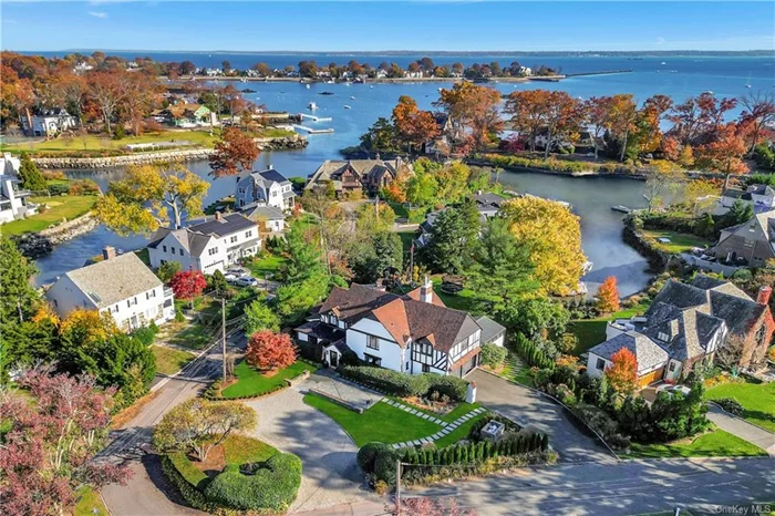 Waterfront bliss and the setting for a spectacular summer! Welcome to this rare harborside sanctuary, nestled in a calm and protected cove, with private dock and access to Larchmont Harbor and Long Island Sound. Sunlit and striking, this beautifully updated Tudor melds original architectural detail with a laidback, breezy vibe. The result is breathtaking crisp white interiors, honey-hued wood floors, Santorini-style archways, leaded windows with stained glass and dreamy alfresco entertaining areas. Each space feels beachy and bright with sun-soaked water views from almost every angle. A four-season sunroom opens to a wraparound deck and a sprawling level lawn that hugs the new seawall for easy access to swimming and boating. Multiple rooms are oriented to embrace the coastal backdrop seriously stylish living room with built-in bar and dramatic picture window, sun filled gym, dining room with original hand-carved arched doors and elegant library/office with soaring ceiling. The chef&rsquo;s kitchen and open-concept family room are pure elegance all new appliances, homework station and sunny breakfast area. On the 2nd floor, five chic bedrooms all with spa-like ensuite baths including the primary with double shower, plus walk-up attic storage. The lower-level is fabulous with a large playroom and beautifully preserved hidden speakeasy! So many highlights with over a half acre of newly designed landscaping, semi-circle driveway and second entrance to the 2-car garage with Tesla charging station. Walk to schools, train, parks and Village and 35 mins to NYC!