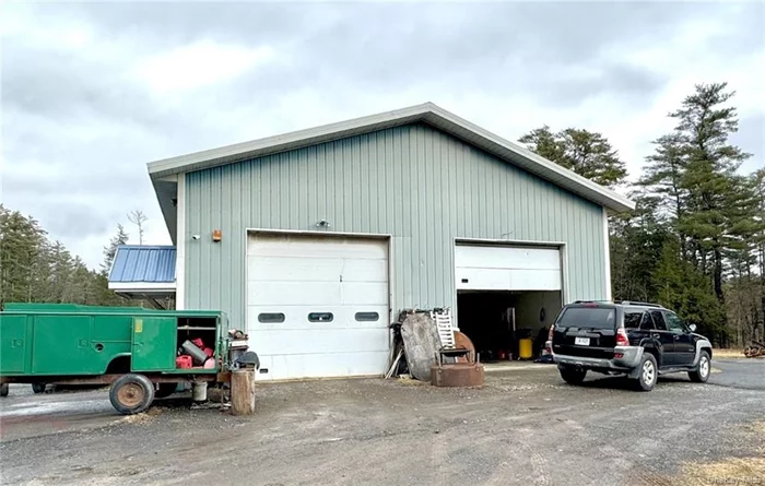 This property consists of two parcels totaling 21 acres. Set back on a hill is a two bay commercial garage 40&rsquo; x 50&rsquo; with 2 bays with 14&rsquo; garage doors. There are two small offices upstairs with a half bath. The two bays are separated by a wall. The right side has a lower ceiling with storage space above and the left side has a wood furnace for heating, the two offices and 2 half baths. One upstairs and one downstairs with a slop sink and hot water heater. There is a four unit apartment building that is 20&rsquo; x 115&rsquo;. There are 2-1 bedroom and 2-2 bedroom apartments. There is a laundry room with two coin operated washer and dryers. There is a class A stream on the right side of the property great for fishing on a hot summer day. There is another room with the boiler, hot water heater and an above ground 1000 septic tank. There are so many opportunities for this land. This is a beautiful piece of property with some lovely views. Flat and sloped cleared land with fields between the apartments and the garage and approximately another 13 acres of wooded land. There are two wells by the apartments. One is new efficient at 50 gal/minute. There is another well near the garage that pumps 100 gal per minute. A special new pumping system was put in to send the water up the hill from theapartments to the septic.
