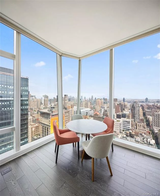 This two bedroom residence features a corner living/dining room, surrounded by floor-to-ceiling windows showcasing stunning Midtown skyline views to the North, East and South. The kitchen features marble countertops and backsplash, Nanz hardware, Sub-Zero and Miele appliances, custom-designed cabinetry by Molteni including a high gloss white lacquer upper cabinetry and framed solid white oak lower cabinetry. Bathrooms feature a handsome selection of marbles, custom wood vanities, recessed medicine cabinets, inset shower and tub niches, and Waterworks fixtures. Residences include 4-pipe fan coil HVAC systems and Kraus home automation systems. The residences at Madison Square Park Tower are perfectly positioned in one of the most iconic and culturally sophisticated neighborhoods in Manhattan- the Flatiron District at Madison Square Park. Transforming the downtown skyline, the soaring tower is a sculptural glass silhouette standing at sixty-five stories rising seven hundred and seventy seven feet in the sky. The striking exterior, crafted by the world-renowned architectural firm Kohn Pedersen Fox Associates, wraps around modern, elegant interiors designed by the celebrated Martin Brudnizki Design Studio. The tower features a 75-foot-wide granite base that fits harmoniously within the tree-lined block and marks a sense of arrival before ascending to eighty-three residences. Floor-to-ceiling windows offer a dramatic cityscape that includes the Empire State Building, Chrysler Building, the clock tower at 1 Madison Avenue, World Trade Center, the Hudson and East Rivers, and Madison Square and Gramercy Parks. The collection of amenities throughout five floors consists of a fitness center with boxing and private training suite, golf simulator, basketball court, childrens playroom, library, billiards, cards room, terrace with outdoor grill, and two gracious entertaining spaces including a fifty-fourth floor lounge.