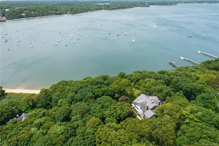 Welcome to 10 Pine Path. This stunning waterfront estate spans 3.79 acres, offering appx. 530ft of Beach Frontage.  With sweeping views of the Long Island Sound & Port Jefferson Harbor, the home has been stunningly renovated to showcase the original details while seamlessly integrating today&rsquo;s modern necessities.  The almost 6000 sqft home features tremendous architectural beauty, plenty of outdoor seating areas, with access to your own private beach.  The interior of the house is a perfect marriage of character and grandeur, with old charm seamlessly mixing with modern design. The main floor boasts a 2 story Grand Room, a central hub of elegance that ties all the main living spaces together, and is wrapped by a stunning enclosed porch. 2 levels of luxury offer 8 bedrooms and a vaulted Family Room.  The grounds are so large they can be subdivided creating enough room for a second 1.36 acre estate with direct beachfront access.  Call for a private showing.