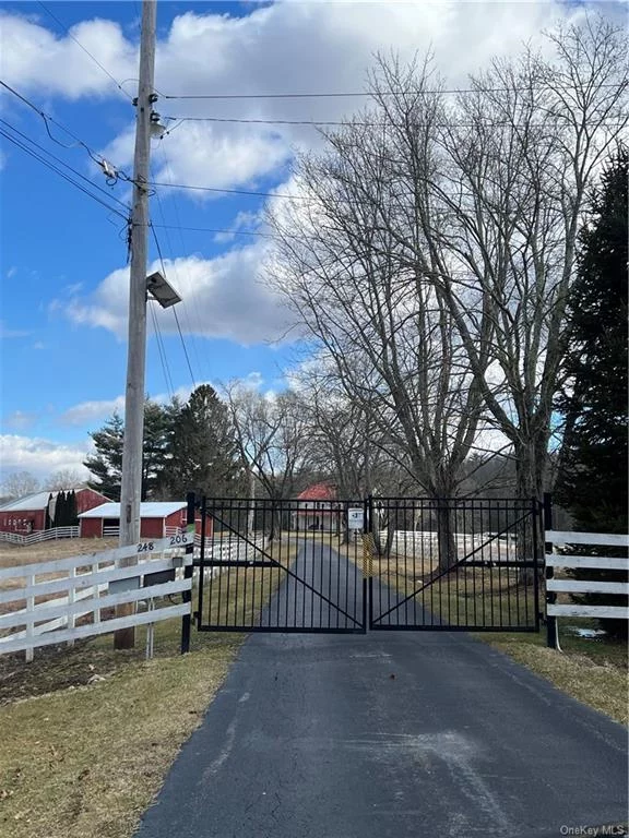 Private long tree lined driveway, black top drive, 1850 farmhouse features 3 bedrooms and 2 baths on private grounds, a patio area, a covered porch, hardwood floors, spacious kitchen, sunny rooms through out, a storage barn, 8 stall insulated barn with electric & water.