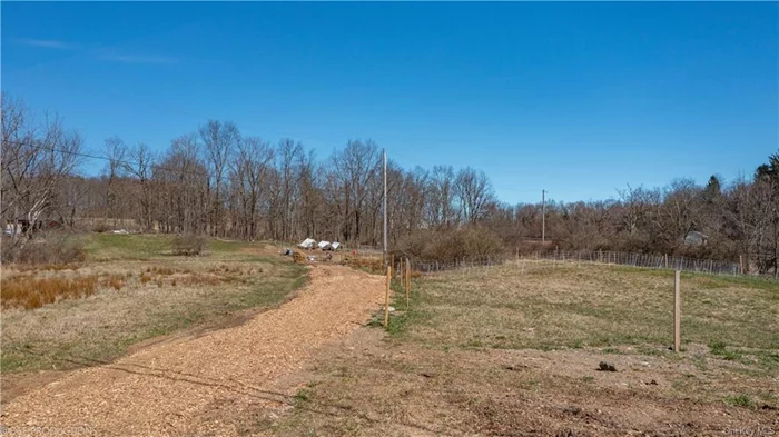 Bring your dream building plans to this scenic 5+ acre tract on Schultzville Rd in the town of Cinton and in the Millbrook Central School District. Site your home at the top of the knoll, gently tucked into the trees behind an old stone wall. This elevation provides a distant site line view, and overlooks the pastoral portion of the property. Located in an area of bucolic agricultural properties, and this location is banded by neighboring horse paddocks. With Board of Health approval for a 4-bedroom residence as well as an accessory barn with bath, just focus on your building plans and breaking ground this summer.