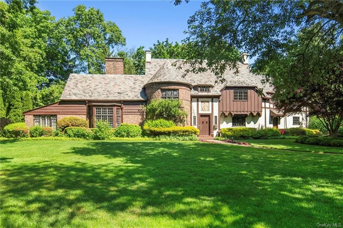 Nestled in the prestigious Gedney Farms subdivision of White Plains, this exquisite home presents a rare opportunity for those with an appreciation of fine architecture and European sophistication. Boasting unparalleled quality construction and old-world craftsmanship, this stunning Tudor-style residence impresses at every turn. The stately brick and stucco facade, complete with a turret and grand circular staircase leading to private quarters, exudes timeless elegance. Inside, beautifully proportioned rooms feature magnificent paneling, moldings, and leaded glass doors and windows, creating an ambiance of refined luxury. The main level offers a seamless flow for entertaining, with a reception foyer, formal living and dining rooms, a study/den, game room, family room with fireplace, and a Bilotta kitchen with service entrance and rear staircase. Upstairs, the master bedroom suite boasts a large walk-in closet, dressing room, and updated en-suite bath, while three additional bedrooms with en-suite bathrooms provide ample space for family and guests. The fully finished attic offers versatile space that can be used as a playroom, gym, home office, or additional living area, catering to your family&rsquo;s needs. The expansive basement houses the laundry area and offers a blank canvas for customization. Outside, enjoy the privacy of the landscaped grounds and the convenience of a two-car attached garage. This home offers a lifestyle of refined luxury and comfort. Experience the unparalleled charm and elegance of 16 Hotel Drive  schedule a showing today.