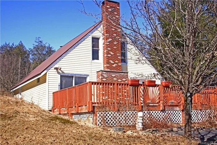 This quaint and charming cape-cod is the perfect little weekend home, located in the remote and quiet Catskill town of Denning at 2, 400 feet in elevation and featuring mountain views. The home sits on 1.5 acres and has a spring-fed pond! The property is banked on two of its property lines by 165 acres owned by the Department of Environmental Protection. Keep warm by the cozy wood-burning fireplace after returning from local skiing and hiking destinations. Enjoy the mountain views from the deck. The neighboring property 708 Red Hill Knolls Rd. is available for sale through another brokerage and owned by a separate seller but buy both and start your own vacation compound! Blacktop driveway installed 2022.