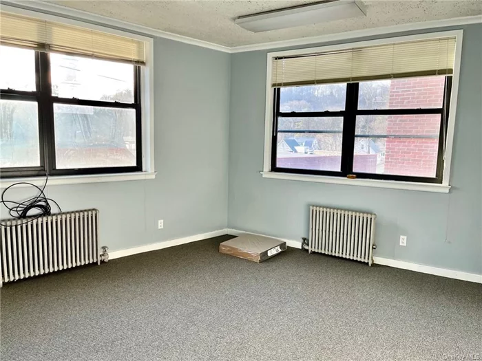 Bright second floor Suite in well-kept Professional Building. 2 Large rooms and adjacent storage roo. Freshly-painted, new w/w carpet. Utilities included. Parking in private lot.