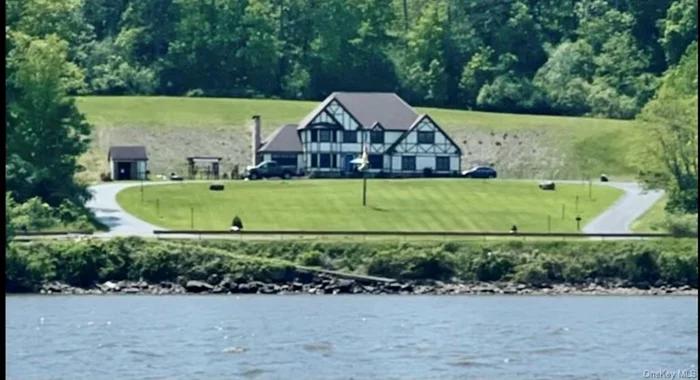 Hudson Riverfront Estate on 5 acres with adjoning buildable lot. 2500 SF Private Tudor Style Home (with security system) overlooking wide expanse of the Hudson River with 200 foot of deep water frontage, includes beach and boat launch. Heated 16x32 inground pool and pool house with bar and 1500 SF patio for entertaining, includes 3 car clear span garage and greenhouse. Walk through adjoining forests. Unbelievable wildlife for observation and hunting.