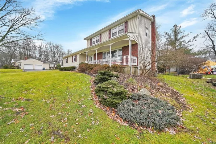 Located at 18 Hillside Terrace in Monroe, NY, this elegant colonial home combines traditional charm with modern updates on a 0.25-acre lot. Situated on a corner lot, It features 1, 934 sq. ft. of living space on the main floors + a 500 sq. ft. fully updated walk-out basement, totaling 2, 434 sq. ft. This home comprises 3 bedrooms, 3 bathrooms, hardwood floors, quartz countertops in the kitchen, and crown moldings that enhance its elegant design. It also features recessed lights in the living room, kitchen and basement. Outdoors, enjoy breathtaking scenic views from the front porch, and a fenced -in backyard, perfect for enjoying privacy and outdoor entertainment. The backyard also has an upgraded trex deck for comfort and efficiency. The home is equipped with a new Central AC system, newer high-efficiency gas boiler with 4 heating zones, an upgraded 220W electric panel with a generator hookup, an alarm service ready (ADT) system for enhanced security, a newer water heater and a central vacuum system. The family room features a gas fireplace with remote control.  The fully updated walk-out basement includes a cedar closet, exercise room, and additional living space. This home offers a blend of privacy, convenience, and modern living, located nearby to shopping, dining, commuter bus & train options, as well as access to nearby highways. Additional amenities include a 2-car attached garage with new doors and an opener, a neighborhood wired for cable and fiber.