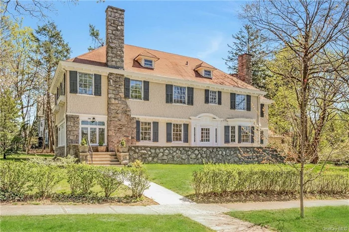This distinguished 7539 sq. ft. Center Hall Colonial is prominently situated on a valuable double lot in the esteemed neighborhood of Pelham Manor. With timeless charm and architectural sophistication, the well-appointed layout features 8 bedrooms, 4.5 baths, and an array of original details, including 5 fireplaces, French doors, handcrafted moldings, back stairs, and beautiful hardwood flooring. The main level greets visitors with an impressive entry foyer with 9+ft ceilings, leading to a formal dining room w/fireplace, a spacious living room w/fireplace and expansive adjoining sunroom, and a library with its own fireplace, creating an inviting living space. The generously sized primary suite offers a large bedroom w/ fireplace, study, and ensuite bath, providing an ideal retreat. With its central location within walking distance to schools, train, shopping, and the village, this home presents a rare opportunity to create your own dream home in Pelham Manor, just 29 minutes from NYC.