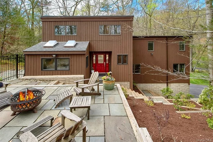Spectacular custom designed contemporary home located in a coveted Whippoorwill neighborhood in the heart of Chappaqua! This home is beautifully sited on two natural wooded acres with dramatic rock outcroppings on a quiet double cul-de-sac offering bucolic views and complete privacy. Architecturally distinctive with soaring ceilings and expanses of glass infusing the home with natural light & tranquil views from every room. Completely renovated and upgraded over the years, the sun filled kitchen opens to spacious dining and living room areas. Sliding glass doors from every room open to the expansive deck and seamlessly blends the interior space with nature. A few steps down leads to a huge family room with a cozy fireplace and custom built-ins. This 4 bedroom home (lives like a 5) boasts a luxurious oversized primary suite with two large walk-in closets and a spa-like bath with heated floors. 3 additional bedrooms, an office/ laundry room and hall bath complete the upper level. The finished walkout lower level includes a recreation room with full bath, perfect for a home office or exercise room,  a convenient mudroom and wine cellar. Relax on the oversized deck and enjoy the serene, zen-like oasis! Recent upgrades include new kitchen appliances, roof, all windows and doors, new garage doors,  new HVAC system including a new AC condenser, boiler, hot water heater; and more. Fully fenced-in backyard. Only minutes to town, schools, parks, train and Whole Foods + Lifetime Fitness at Chappaqua Crossing. A special home not to be missed!