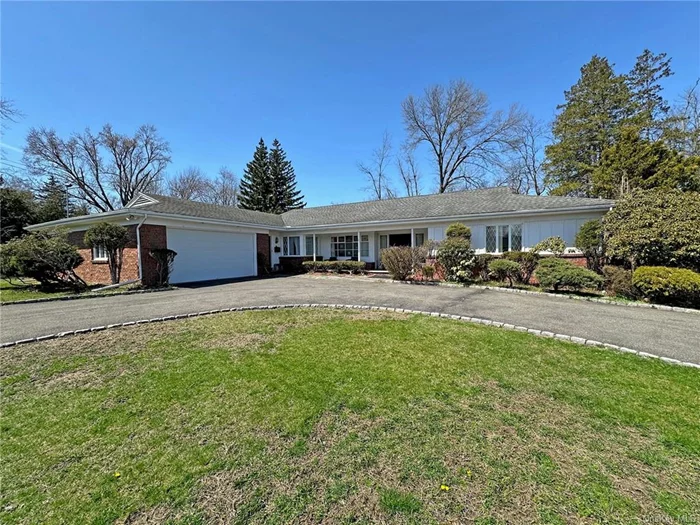 This 1960&rsquo;s sprawling ranch has 4 large bedrooms and 3.5 baths room to breathe inside and out! From the second you drive into the extra-wide cul-de-sac you begin to relax. Peace and quiet in uptown Kingston was never so complete as on this double-lot parcel. It has all the amenities, and then some: an oversize 2-car garage, a stone fireplace, a sun room, a graceful half-moon stone patio, a large park-like yard, and even a tennis court! Step into a large foyer with two main bedroom suites to one side; and then living, dining, and family rooms to the other. Easy circular flow and an eat-in-kitchen that includes corner windows, wood counters, a 6 burner cook top and a breakfast bar. Windows, windows, and more windows. Skylights as well in the family room with two sets of glass sliders (that straddle the stone hearth) and open into a 10 x 30 tiled sun room with an indoor BBQ grill, or, let your party spill out onto the half-moon shaped stone patio where you can enjoy iced tea as you watch your guests play frisbee or croquet! The yard is expansive and includes a fully-fenced tennis court. It might also support a pool if desired. The 2-car garage opens to another smaller foyer/side entrance and makes it easy to bring in groceries to stock the hallway pantry closet. Down the hall are 2 more ample bedrooms that share a classic blue mid-century bath. Close proximity to uptown Kingston&rsquo;s shopping, farmer&rsquo;s market, schools, and many restaurants provide city-central living and yet you are minutes to Woodstock, Saugerties, and the Catskill Mountains. Bring your boat and your skis, and your green thumb (start your own mini-farm right in your own back yard). Need storage? You could play shuffleboard down in the basement or create a space to store your wine collection, have a craft studio, or to make Limoncello. This home has it all ... including: a newer roof, an automatic generator, central A/C, and city water and sewer. With a bit of updating and your personal touches this ranch home will be the talk of the town.