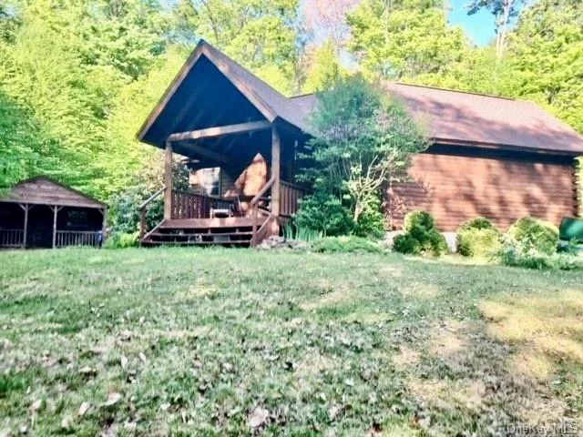 Lovely Beaver Mountain Log Home on 5 acres on town maintained road. Cathedral ceiling, small loft, oak floors, jacuzzi and wood stove. Spacious front and rear decks for entertaining and relaxing, small shed, separate Bunk house or studio space now set up as a 2ND BR, full dry basement for added storage .  Fishing and boating rights on Emerald Lake - close to Hamlet of Downsville, the Pepacton Reservoir as well as thousands of acres of NYC & NYS lands for all your outdoor activities!. This is a rare find and must be seen to be appreciated.... House was recently stained and roof has a 35 year warranty. Come see this lovely property!