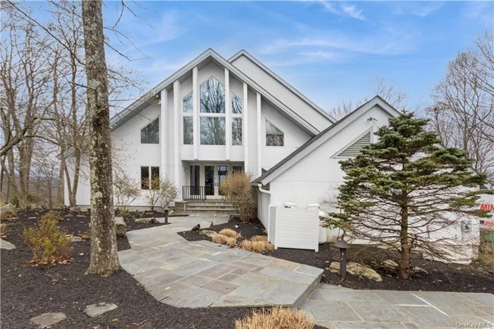 Enjoy AMAZING westward views for miles from this stunning contemporary overlooking the Hudson Valley. A bluestone walkway welcomes you to the front door, and as you enter, you can see right through the living room through floor-to-ceiling windows at the view beyond. A granite fireplaces flanks the left wall. To your right, an open eat-in kitchen, with gleaming granite tile floors. Primary suite with large bath on the main floor. Office/bedroom to your left and half bath to your right. Up the stairs to 2nd level with two bedrooms and bath, then up one more flight to TV or game room and on up to a loft area. Full, bright walkout basement with deck and views. West bedrooms have tremendous views and there is access to decks on three levels taking advantage of the views. Hike the nearby Appalachian Trail access, and enjoy the Town owned Shenandoah Lake down the street. A home filled with light and generous space, you will truly be proud to call this special custom residence your home.
