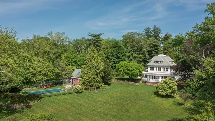 A landscape worthy of the Hudson River School, with panoramic views of the Palisades lining the western side of the Hudson, this handsome 1905 clapboard Colonial residence is a sanctuary from the bustling city life just 20 miles away. With over two acres of rolling and verdant lawns, the Hudson River is a constant presence. Completely and artfully rebuilt in 2010, by noted local architect, Stephen Tilly, the interior design embraces early 20th century elegance and essence while impressing with modern amenities and comfort. No detail was spared: from the hipped roof with balustrade, premium materials like cypress woodwork shingles and solid bronze hardware to the wrap-around colonnaded veranda that ensures lovely breezes and stunning sunset viewing. Masterful renovations to the main house include converting several small interior spaces on the ground floor into a large open plan that&rsquo;s drenched in sunlight thanks to all-new oversized windows. Timeless architectural details include crown molding, decorative millwork, 9 ft ceilings and wide-plank oak floors. Perfectly preserved from the original home is the classic front staircase with rope spiral pattern balusters. The sunlit kitchen with center island and chef grade stainless steel appliances spills into a family room featuring gas burning fireplace and doors to lawns and gardens. On the second floor, the palatial primary bedroom enjoys 3 exposures with epic river views, dressing room and a sprawling bath with soaking tub. Across the landing, an office/bedroom has its own full bath. The third floor offers myriad options for family and guests with 4 perfectly proportioned bedrooms, full bath with stylish salvaged antique tub and storage. Over 2 secluded acres of meandering gardens and specimen trees include mature horse chestnuts, sycamores and copper beech, the heated Gunite pool and Pool House are privately tucked among the idyllic scenery. This heritage riverfront estate offers a rare opportunity to possess a refined country getaway a half-hour from Manhattan. Hastings-on-Hudson is a famously friendly and vibrant village with its exceptional galleries, cafes and bistros and Farmer&rsquo;s Market. The commute to Grand Central is under 40 minutes with river views along the way.
