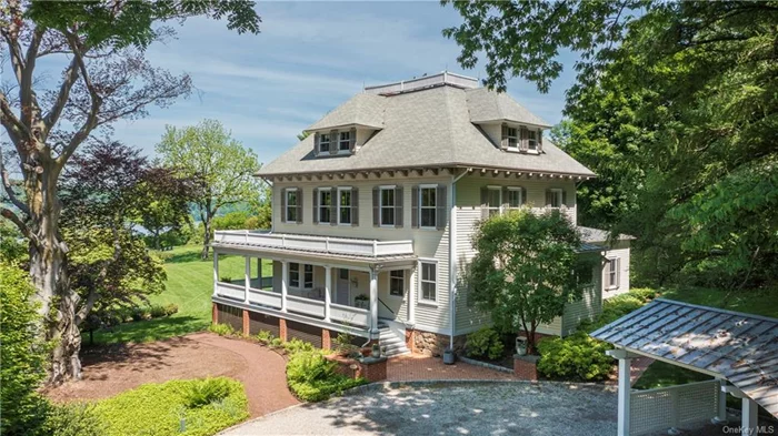 A landscape worthy of the Hudson River School, with panoramic views of the Palisades lining the western side of the Hudson, this handsome 1905 clapboard Colonial residence is a sanctuary from the bustling city life just 20 miles away. With over two acres of rolling and verdant lawns, the Hudson River is a constant presence. Completely and artfully rebuilt in 2010, by noted local architect, Stephen Tilly, the interior design embraces early 20th century elegance and essence while impressing with modern amenities and comfort. No detail was spared: from the hipped roof with balustrade, premium materials like cypress woodwork shingles and solid bronze hardware to the wrap-around colonnaded veranda that ensures lovely breezes and stunning sunset viewing. Masterful renovations to the main house include converting several small interior spaces on the ground floor into a large open plan that&rsquo;s drenched in sunlight thanks to all-new oversized windows. Timeless architectural details include crown molding, decorative millwork, 9 ft ceilings and wide-plank oak floors. Perfectly preserved from the original home is the classic front staircase with rope spiral pattern balusters. The sunlit kitchen with center island and chef grade stainless steel appliances spills into a family room featuring gas burning fireplace and doors to lawns and gardens. On the second floor, the palatial primary bedroom enjoys 3 exposures with epic river views, dressing room and a sprawling bath with soaking tub. Across the landing, an office/bedroom has its own full bath. The third floor offers myriad options for family and guests with 4 perfectly proportioned bedrooms, full bath with stylish salvaged antique tub and storage. Over 2 secluded acres of meandering gardens and specimen trees include mature horse chestnuts, sycamores and copper beech, the heated Gunite pool and Pool House are privately tucked among the idyllic scenery. This heritage riverfront estate offers a rare opportunity to possess a refined country getaway a half-hour from Manhattan. Hastings-on-Hudson is a famously friendly and vibrant village with its exceptional galleries, cafes and bistros and Farmer&rsquo;s Market. The commute to Grand Central is under 40 minutes with river views along the way.