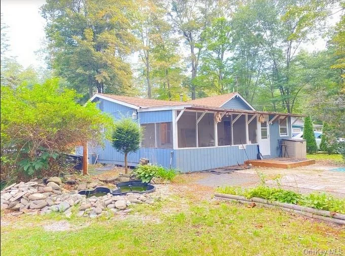 Live a one-minute walk from scenic Neversink River! This cute bungalow in Myers Grove includes two bedrooms and one bath, with a charming outdoor area feature a two-level koi pond, outdoor kitchen, and large workshop space with three connected sheds. Enjoy nature, privacy, and peace in the shaded yard in summer, or snuggle up indoors by the wood burning stove in winter. A new wall unit efficiently heats or cools the entire house. The property is being sold with the adjacent lot (29-9-12, 0.12 acres) that is potentially buildable for an additional home or investment property! Minutes away from natural scenery, hiking and biking trails in picturesque Deerpark, NY. Some updating required. Property is being sold as-is. Cash buyers strongly preferred.