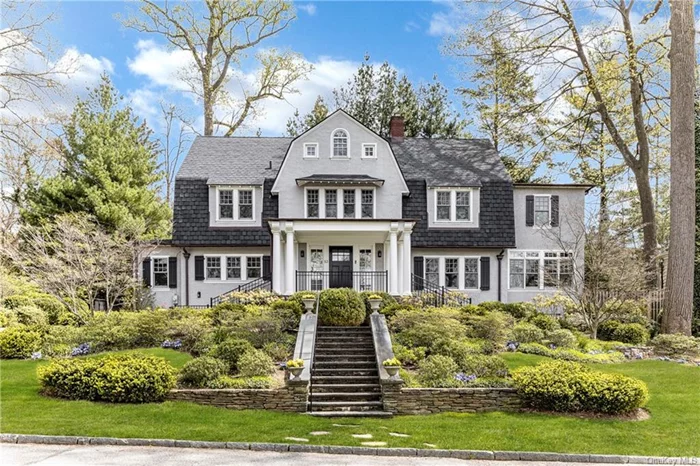 The heartbeat of classic Bronxville, fully elevated for 21st century living. And stunning sunsets are complimentary! Designed in 1910 by premier architect William Bates, this stunning 5 bedroom center hall Dutch colonial underwent a massive 3 story renovation and expansion in 2015-2016 which yielded modern and elegant living spaces both inside and out. The dramatic vibe of the oversized front foyer with its stunning ceiling height and custom built staircase sets the stage for a stylish living room with gas fireplace. Beyond the LR, an expanded sunroom has French doors leading to a new oversized bluestone patio which overlooks the professionally designed flat play yard. Best of all, the state of the art cooks kitchen with its 9 ft long island is complemented by an expanded sitting area adjoining the mother of all mudrooms and a brilliantly designed custom built dog room with Dutch door. Not to be upstaged, the formal dining room has a wall of windows and features super elegant neutral tone Venetian plaster walls. Upstairs, the owners created a dreamy primary BR with fireplace, walk in closet and expanded Waterworks marble bath with double sinks. There are two other new ensuite BR/baths on the second floor and two BRs/office on the third with a new hall bath, plus a delightful windowed office area with custom built in desk. And the lower level is a game changer: Expanded and reimagined with custom cabinetry, LED lighting, new egress windows and a modern interactive art installation, the family room, gym and full bath offer 1500 sq ft of legal living space for work or play. All this plus an easy downhill walk to Bronxville School and village. With too many improvements to mention, please see Amenity list attached.