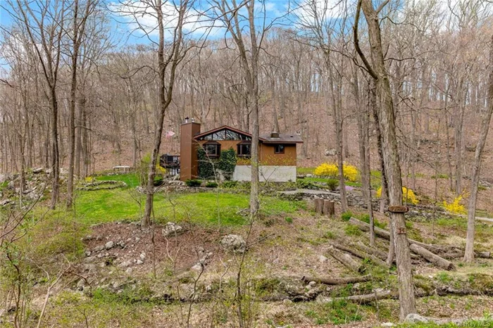 Located off of one of the prettiest roads in Cold Spring, this custom-built home backs up onto NY state protected lands; you couldn&rsquo;t ask for a better location. The owners built this house for themselves and have meticulously maintained it over the years, it is a one of a kind offering and the care and love are evident throughout. Step right into an open and bright living area w/large windows, a vaulted ceiling, wood-burning stove and walkout patio which functions more like a second living room in the warmer months. Entertaining is a breeze with a dining alcove and an open kitchen with island seating. The primary suite boasts a newly renovated bathroom with a soaking tub. Two additional bedrooms, a full bath, and a laundry room complete the main floor. A bonus lower level space is an ideal office/tv room with a dedicated storage space and connects to the two car garage. Enjoy the outdoors and privacy at your in-ground pool; the beautifully landscaped yard will delight: it is vacation all summer long here. What makes this property truly special is not only its convenience (close to everything, including the village of Cold Spring, Metro North station and Route 9 with all of its shopping), but tucked away in a most-serene setting. Move right in & enjoy Hudson Valley living. This home is ready for its new owner!