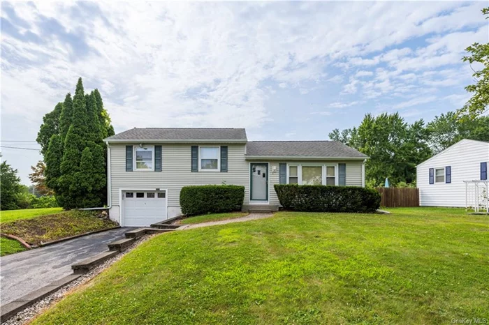 Lovely split level home nestled on a large corner lot in desirable neighborhood boasts updated kitchen with dining area, spacious living room and dining room have hardwood floors beneath carpeting, DR provides access to screened in back porch on first level, 3 bedrooms with hardwood floors, full bathroom with retro pink and black tiles on second level. The lower level hosts a family room, laundry/utility room and access to one car garage. But wait there&rsquo;s more, the beauty of this style house is the basement that adds additional space for storage, work space and new above ground oil tank. A large portion of the back yard is fenced in. Conveniently located close to shopping, dining and Route 9. This is a must see.