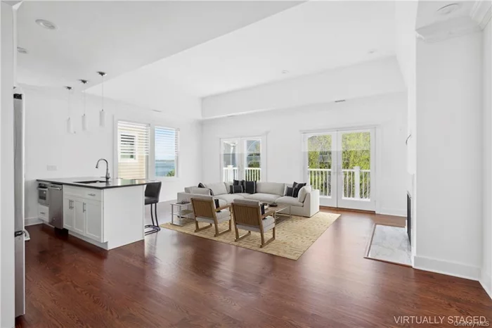 Located in the serene gated community of City Island, Bronx, this 3 bedroom, 3.5 bathroom condo features 11-foot ceilings, natural light, a gas fireplace, and hardwood floors. Double French doors open to a 23-foot terrace with water views. The kitchen boasts Caesarstone countertops, white maple cabinets, and GE Profile appliances. The primary suite offers two closets, an en-suite bath with Carrera marble and double vanity. Built in 2017, the home includes Andersen windows, central air, and a smart washer/dryer. An indoor garage and extra storage enhance its value. Walking distance to local amenities, this 43-unit waterfront development includes a clubhouse with fitness center, heated pool, and playground. It represents luxury living with the community spirit of City Island.