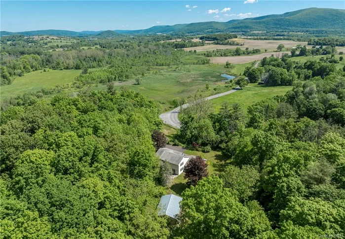 This country home blends traditional charm with modern conveniences and is situated on 17 acres with views down the valley to the Taconic Hills and Berkshire Mountains.&#160;This four bedroom, three and one half bath home is surrounded by beautiful farmland including nearby Herondale Farm and pick your own Thompson Finch Farm. The first floor provides a spacious, open floor plan with vaulted ceilings and oak floors. A double sided fireplace is shared between the living room and sitting area. The large country kitchen has granite counters, ample cabinet space, and a wet bar. French doors from the dining room lead to the stone terrace, a perfect location for outdoor dining. There are two bedrooms, an office, laundry room and two and one half baths also on the first floor. The second floor has two bedrooms and a bath. Outside, there is a large barn, perfect for storing equipment or setting up a workshop. Located in the Columbia Land Conservancy, this property provides a peaceful escape. Convenient to Copake and Ancram and 2 hours to NYC.