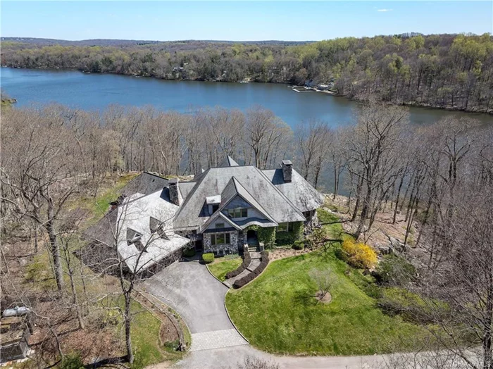 Stunning Cedar and Stone masterpiece on Lake Waccabuc. Situated on nearly 16 acres of land with over 1, 000 feet of lake frontage behind a gated drive and designed by noted architect Tasos Kokoris, this warm and stately home embodies old world style and craftsmanship designed for today&rsquo;s perennial or weekend lifestyle. Drink in the breathtaking views from the many sunlit rooms overlooking the lake. Inviting entertaining spaces include a formal dining room with wood and glass bar and a living room which opens to the sunroom, each warmed by fireplaces and wide-plank oak floors. The newly renovated, custom kitchen with quartz counters and Viking & SubZero appliances, flows to the screened porch. The upper level offers a spacious primary suite with 4 additional generously apportioned bedrooms. Additional features include high ceilings, natural light in every room, multiple bluestone terraces, slate roof, two recreational showers and a lake-front guest cottage with kitchen, den, bath and loft, just steps from the dock on Lake Waccabuc. A piece of paradise, 10 minutes to Metro North and just over an hour to NYC.