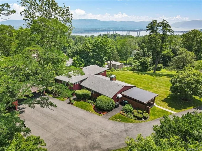 Designed by the renowned architect Gordon S. Marvel, this unique split-level home in Balmville is a mid-century masterpiece with mountain and river views. The home provides a museum-quality experience and boasts an abundance of original details such as Geneva cabinets, mosaic tile and sunken tub. Marvel was known for utilizing space and he made generous use of built-ins throughout this gem. Other design elements, such as fine parquet floors and the brick hearth that flanks both the living and dining rooms, provide the full palette of the mid-century aesthetic. The home offers three spacious levels of living space, all bathed in sunlight from the artful placement of windows. Upstairs are four bedrooms; two with full baths and two that share a jack-and-jill bathroom. The main level is a classic open floor plan with living room, kitchen and dining room fronted by a wall of floor-to-ceiling windows. An enclosed blue-stone patio is located off the dining room and offers views of the grounds and valley beyond. Downstairs, a large family room is outfitted with a kitchenette and a full bathroom, for a total of 4.5 baths. The park-like estate of 1.5 acres provides a serene setting for this magical home and affords panoramic views of the Hudson Valley. Nestled in the hills of Balmville on a cul-de-sac, within walking distance of the Desmond Estate. Close to Beacon, Dia museum , wineries, hiking and all the recreational activities the Hudson Valley offers! Min. to Metro North train to NYC, NYS thruway , I84.