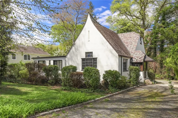 This one of a kind, bright four bedroom, two-and-a-half bath dramatic Tudor is oozing in charm and has many architectural details to enjoy. Conveniently located, it is close to the Heathcote Elementary School, Five Corners shopping area and bus to the Scarsdale Train Station. The stained glass windows in the living room and dining room are magical as is the unusual fireplace and Juliet balcony on the staircase from the second to third levels. There is both a stone patio in the front and an expansive wood deck in the back for tranquil outdoor enjoyment. Square footage does not include the 278 square feet in lower level. Don&rsquo;t miss this unique and special home!