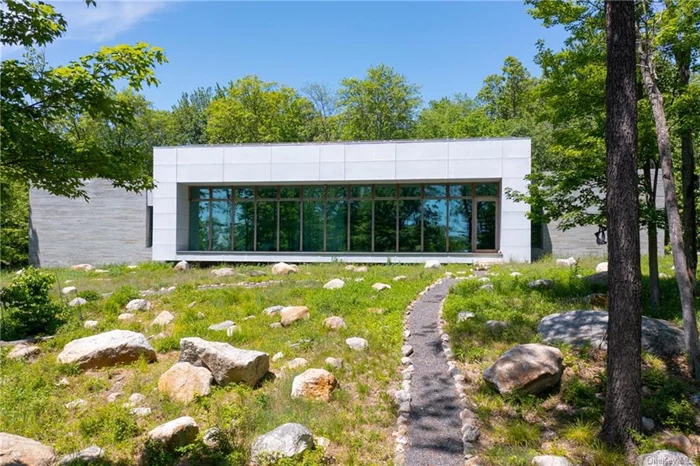 A House in the Woods. Welcome to the architectural brilliance & contemporary luxury. This 4-BR, 4.5-BA, 4, 071-sf home abuts the Awosting Reserve & is sited on 8.49 acres, with no neighbors in sight. Step inside & be greeted by natural light streaming through 15-ft floor-to-ceiling windows. Designed to exacting specifications & LEED silver-certified, there are 74 roof-mounted solar panels, radiant-heat flooring, an open-concept kitchen, custom cabinetry & top-grade appliances. A mere 2 hrs. from NYC, 30 mins. to New Paltz & 40 minutes to the Poughkeepsie Metro-North/Amtrak station.