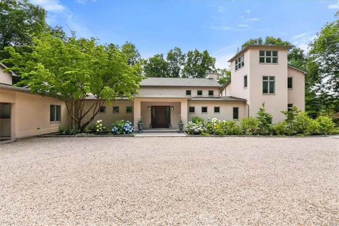 Step into a one-of-a-kind, stunning Mediterranean-style expanded ranch. This home boasts soaring ceilings, bathing every room w/abundant natural light through walls of windows. Great room features a cozy fireplace, while the dining room sets the stage for entertaining. Eat-in kitchen w/center island opens to the family room, complete with built-ins, a fireplace, leading to a screened porch. Main level primary suite is a retreat in itself-a bedroom that opens to the patio - dressing area , countless closets, & spa-style marble en-suite bath. Home office, 2 powder rooms, & mudroom complete the first floor. 2nd floor presents 3 additional bdrms & full bath. Nestled on private 4-acres , this home offers a gated courtyard entry, surrounded by beautiful gardens, providing a serene and secluded oasis.Conveniently located minutes from shops, Metro North train station, & restaurants of Mount Kisco Village. Low taxes, move-in condition, & impeccable maintenance, this home is a rare find.