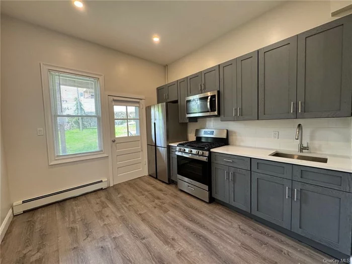 Experience luxury living in the heart of Harrison with this newly renovated 2 bedroom, 1 bathroom unit. Boasting a spacious living area with 16 Ft. ceilings, modern eat-in kitchen w/ SS appliances, and two generously sized bedrooms. Enjoy the privacy of your own patio and shared backyard, just a short walk from the Harrison shopping district and metro north. 38 Minutes to GCT.