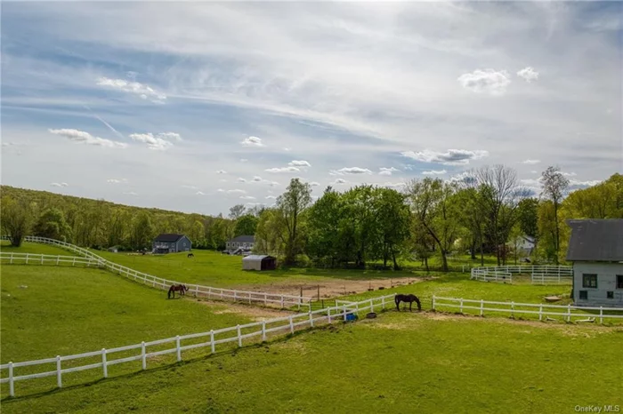 Step into a piece of Hudson Valley history with this exceptional horse farm, originally built in 1922 by the military to house the first cavalry horses in the area. This peaceful, historic property seamlessly blends its storied past with modern amenities, making it a rare and beautiful find. The impressive main barn, a testament to its rich heritage, features a spacious center aisle illuminated by overhead LED lights. It includes 10 stall spaces, with 8 original stalls and 2 newly constructed in 2017. Among the stalls, you&rsquo;ll find a double-sized foaling stall, 4 stalls with a concrete base (including the oversized foaling stall currently used for a Percheron Draft cross rescue), and 6 stalls with a dirt/stone dust base. Six of the stalls are matted, and while 5 are in current use, others serve as storage for hay and barn supplies. The barn also boasts renovated office and lounge areas, transforming two rooms into lovely, functional spaces. A bathroom adds convenience, and a kitchen space with electric and water hookups, counters, and cabinets offers potential. The expansive loft, historically used for hay storage, presents an opportunity to be divided and transformed into a breathtaking living or event space. The property is ideal for equestrian pursuits, featuring 2 grass paddocks with vinyl fencing, an extra-large grass paddock with Electrobraid fencing and a large shelter, a 70-foot diameter sand footing round pen, and 2 well-drained grass riding and jumping fields. The scenic landscape is adorned with beautiful rolling hills, natural rock outcroppings, and a tree-lined perimeter, creating a picturesque setting. Additional buildings include a shed row added in the 1960s, which contains a small vinyl-fenced grass paddock and 5 stalls historically used for mares, foals, and a larger stallion enclosure. The current owners utilize this space for barn equipment storage and manure composting, but it offers considerable potential for various uses. Nestled on a hill overlooking the property, the spacious and immaculate ranch-style home offers comfort and tranquility. It features two fireplaces providing warmth and ambiance, a generous living area perfect for gatherings, and three spacious bedrooms. A full unfinished basement provides ample storage space or the potential for additional living areas. Enjoy the serenity of the front porch, perfect for morning coffee or evening drinks. Watch your horses graze while taking in the breeze or sunset, making it an ideal spot for relaxation and conversation with friends and family. This Hudson Valley horse farm is a unique gem, offering a harmonious blend of historical charm and contemporary functionality. Don&rsquo;t miss the opportunity to own this exceptional property. It&rsquo;s truly a once in a lifetime opportunity.
