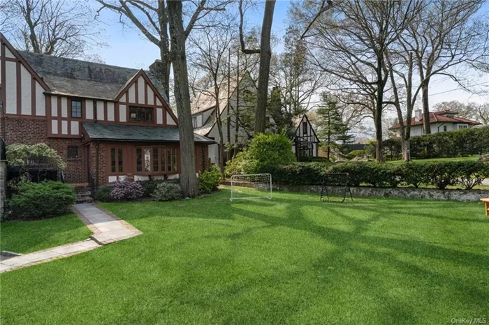 This beautiful English Tudor home with wonderful original details is located on a charming street in Old Edgemont - just a short walk to Scarsdale Village shops and restaurants, the Metro North train to NYC ( 30 min.), Seely Place Elementary School and the Edgemont Jr. / Sr. High School. This 4 bedroom home features a spacious living room and dining room, a beautiful sunroom located just off of the eat-in-kitchen, a primary bedroom suite with updated bath, 3 family bedrooms with an updated hall bath, and is situated on almost 1/3 acre. There is plenty of space for comfortable family living and entertaining, both indoors and outdoors. If you are not quite ready to purchase a home, there is no better introduction to suburban living and the Edgemont School District than 27 Bretton Road!