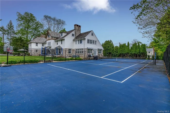 Welcome to this exquisite 5-bedroom, 5/12-bathroom home, boasting 7, 000 sq/ft of sophisticated living space in a sought-after section of New Rochelle. This rare gem is one of a kind sitting on over 3/4 acre with a private tennis court. This home features generously sized rooms with beautiful architectural details. The spacious eat-in kitchen is a culinary enthusiast&rsquo;s dream, with two sinks and two ovens. The first floor boasts an elegant living room with fireplace, dining room, family room, a powder room and a sunroom/game room. Additionally, there is a separate room which can be used as either an office/bedroom.  Second floor offers a stately master bedroom which provides for a luxurious retreat with master bath, sitting area and fireplace. There is a second master bedroom with its own bathroom as well as three other bedrooms. The third-floor features storage and three finished rooms which are currently being used as a pool room, playroom and a guest bedroom with bathroom.