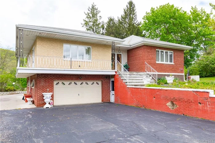 Situated on a 2-acre lot with frontage on the scenic 10 Mile River. The property boasts a charming 2-family home. The exterior has a wrap-around deck with spacious living areas inside for both comfortable living and entertaining guests. The expansive outdoor patio is another standout feature. The interior features hardwood and ceramic tile floors throughout. The house is clad in brick with a retaining wall giving it a timeless and elegant aesthetic.  A 2-car attached garage, a detached garage/workshop, offers storage options or a place for hobbies & projects. The main house boasts 3 bedrooms & baths. A lower level summer kitchen, provides a space for preparing meals during the warmer months and holidays. Two stone fireplaces add a touch of warmth and coziness. In addition to the main house, there is a spacious apartment unit that is perfect for extended family members or as a rental to help offset the mortgage. The apartment includes 1 bedroom & 1 bathroom.