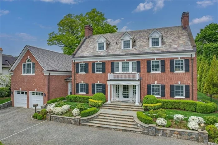 Elegant and extremely rare all-brick Colonial perfectly located on one of the most beautiful and sought-after streets in Scarsdale. This exceptional and admired residence seamlessly blends prized classic architecture with modernity and exemplifies sophistication, character and timeless elegance.  A stately setting with a circular drive surrounded by meticulously landscaped grounds and wide stone steps to the front terrace exudes a sense of arrival to the well-appointed residence showcasing impressive old-world grandeur updated with today&rsquo;s modern amenities. Fully and tastefully updated in 2013/2014 and spanning 7, 662 square feet, this home presents a truly unique opportunity. A beautiful setting on over 1/2 acre level and private backyard, this residence is complete with a gorgeous pool with spa surrounded by a limestone patio.  The stately formal entrance hall welcomes guests with its impressive proportion and grand wrap-around staircase detailed with a windowed landing that spans all three floors. The stunning entrance hall sets the tone for the exquisite formal and informal interior spaces that follow.  The main level offers grand living spaces designed for elegant entertaining and casual everyday enjoyment. Oversized windows provide generous sunlight and picturesque views of the lush grounds, sparkling swimming pool, and patios. The center hall layout features an expansive formal living room with a fireplace that opens to a glass-enclosed room (currently used as a dining room) with views and doors to the property. A formal dining room (currently used as a family room) features coffered ceilings and a beautiful fireplace. This grand space features a versatile setting for stylish living.  The heart of the residence is the spectacular eat-in chef&rsquo;s kitchen appointed with top-of-the-line appliances, all-white cabinetry, and an oversized center island all with white marble countertops. The kitchen features a generous separate breakfast area and a built-in desk and is open to an airy sun-filled family room/playroom surrounded by windows and glass doors to the pool and property. Conveniently located off the kitchen is a mudroom with custom built-ins, a side door, and direct access to the attached two-car garage. Two elegant powder rooms, one formal and one informal, complete the first level. On the second level, there are four spacious ensuite bedrooms, including the breathtaking primary suite. The luxurious primary bedroom with vaulted high ceilings, features a large separate sitting room with a fireplace and a large dressing area that opens to two oversized custom-fitted walk-in closets. The primary closet is a fashionista&rsquo;s dream come true offering floor-to-ceiling storage, a center island and a balcony. The dressing area also opens to the modern, spa-style white marble primary bathroom with high ceilings, a standalone soaking tub, a glass-enclosed shower, and two separate vanities.  The third level offers a large bedroom, an expansive recreation room, a fully renovated bathroom and a spacious laundry room. The walk-out lower level features a state-of-the-art temperature-controlled wine cellar and a gym (both of which are included in the total square footage). The lower level also features ample storage space and pre-designed spaces allocated for a bedroom with plumbing for a full bathroom that can be fully finished. With its impeccable craftsmanship, traditional design, and updated interiors, this breathtaking Scarsdale residence offers a rare opportunity to move right in and enjoy unparalleled luxurious living within 35 minutes of Midtown, Manhattan!