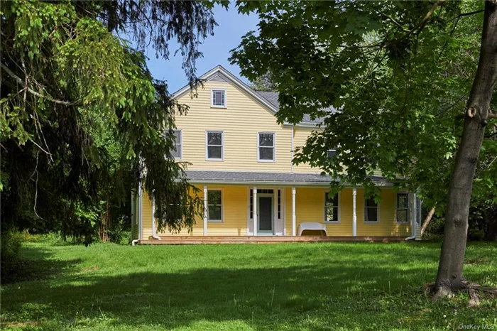 At last, a rare find fulfilling so much of your country vision! Situated on almost 5 beautiful acres along a quiet walking and biking road, this late 19th century center-hall is replete with original details. The sunset facing full-length covered porch welcomes you onto gleaming restored floorboards throughout this residence. Everywhere, high ceilings and tall windows create a fresh and light ambiance. Comfortable double parlors, one intimate with a sweet fireplace and antique mantle, the other more airy and spacious, flank the entry foyer w/its original stained glass. The large, fully equipped sunlit eat-in kitchen is a lure to prepare a farm-to-table meal to enjoy here, on the wooden deck facing the lush greenery, or in the delightful dining room for a more formal evening. Up the stairs with the original banister and newel post, we find a special landing to cozy up with a late-night book or morning brew as well as 4 generous and light corner bedrooms. Outside for your checklist of special amenities! The 1600sqft 2-story Studio w/electric is perfectly sited within an expanse of green lawn, willows, and a mulberry tree. Its unique fenestration and exquisite north light provide a sanctuary-like experience for your own creativity in any medium - may it be art, music, movement, or perhaps professional space. The 3-bay quite charming garage, with a hip roof and lovely windows, offers plenty of room for vehicles and country gear to indulge your athletic side. The property boasts lovely mature, aromatic flowering and shade trees, as well as a meditative old-growth pine grove. Private, yet not isolated; away yet convenient to Great Food, Antiques, Galleries, and activities throughout Rhinebeck, Red Hook, Tivoli, Germantown, and Hudson. This original buttercup yellow Moore Road house awaits her next chapter providing you a canvas to build your own sweet memories. She&rsquo;s gracefully aged with a youthful demeanor.