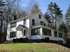 Country style Colonial home on 2.5 acres. Original woodwork, hardwood floors, (under existing carpet) Bluestone fireplace in living room,  formal dining room, kitchen with center aisle w/sink, pantry, laundry room, 2 full baths, foyer with stained glass, walk up attic, attic ceiling fan, full basement with garage entry. Large yard with BBQ fireplace area. Close to Delaware River, restaurants, post office, and a short drive to Bethel Preforming Arts Center.