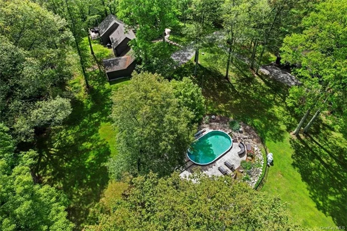 Welcome home to your wooded paradise! This 3000+sf home on 8 acres is a private oasis which lends itself to multi generational living as well as working from home. Off the entry hall is an open floor plan LR with beautiful stone fplc, DR with sliders out to expansive deck & recently renovated kitchen. Down the hall is the laundry, renovated full bath & large room with high ceiling & WIC, currently being used as a main floor master. Off the living room is a den/office as well as 2 more main floor bedrooms & full bath. Upstairs is a master suite with full bath & WIC. The partial bsmt has utilities & crawl space access & walks out to the front & rear yard. There is an additn&rsquo;l finished area accessible from driveway as well as bsmt, which was previously used for a home business. Detached 3 car garage w/electric offers plenty of storage & loft. Semi inground pool partially sunk in & fenced in. All hardwood floors just refinished. Large pond in front. PBSD